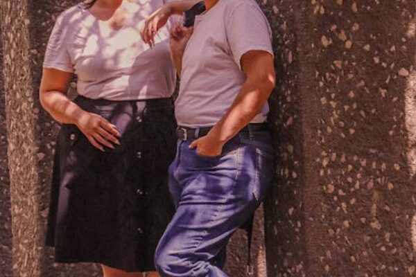 free-photo-of-couple-in-sunglasses-standing-on-the-sidewalk